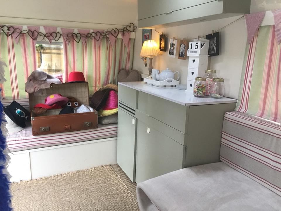 Inside the caravan — striped curtains, props laid out and the booth ready to go