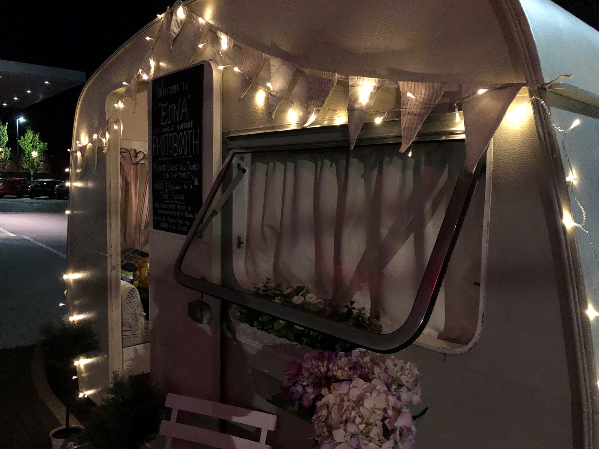 Fairy lights strung along Edna's awning rail after dark