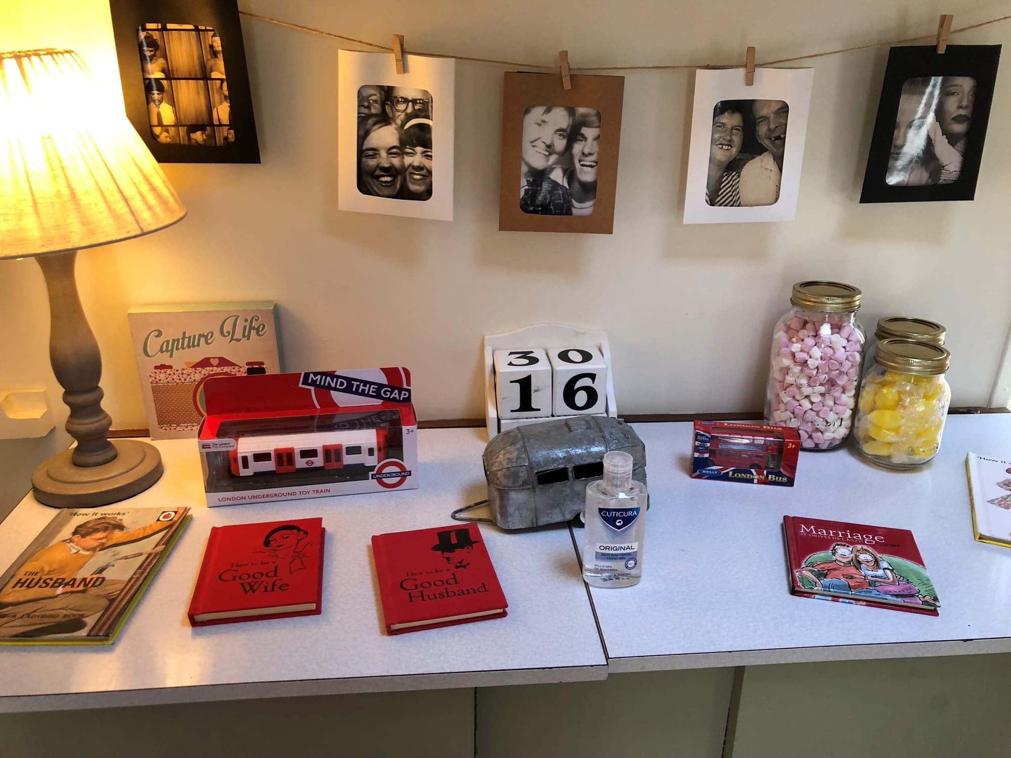 Photo prints pegged up on the display table